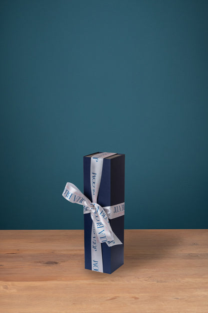 The Jula Bloom luxury gift box, closed and ribboned, on a table