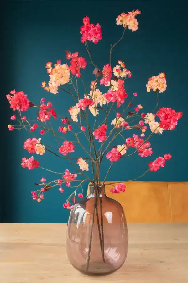 Jula Bloom’s Rosa silk flower bouquet with peach and pink blooms, in a semi opaque brown glass vase