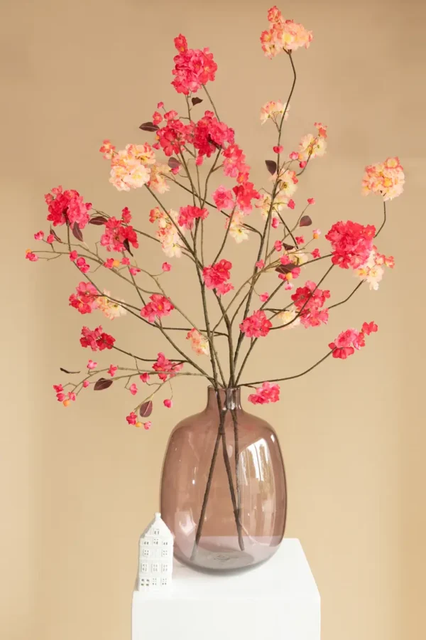 Jula Bloom’s Rosa silk flower bouquet with peach and pink blooms, in a semi opaque brown glass vase