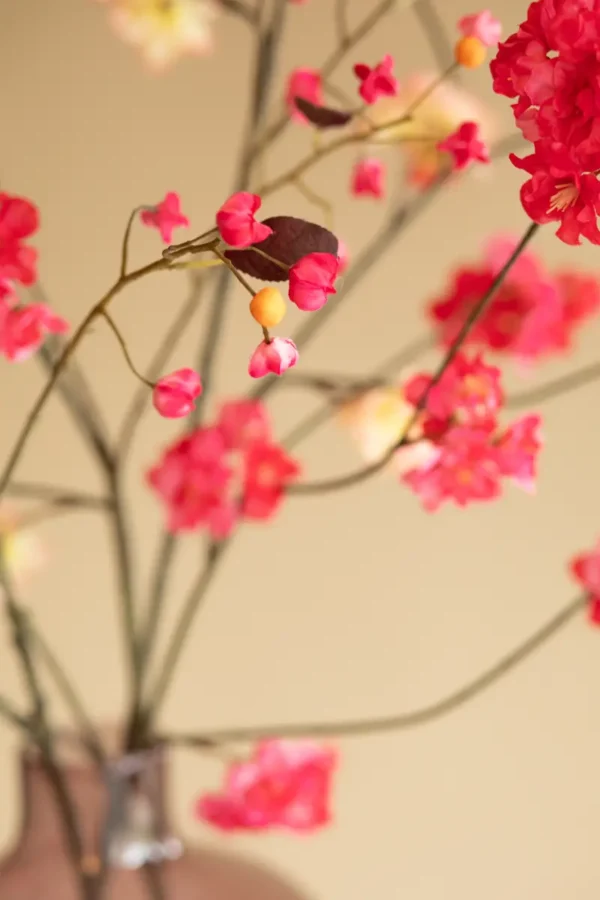 Close up of Jula Bloom’s Rosa silk flower bouquet with peach and pink blooms