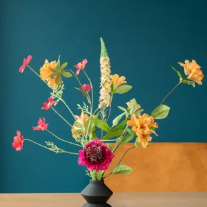 Jula Bloom’s Coco silk flower bouquet with orange, yellow and pink blooms, in a black vase