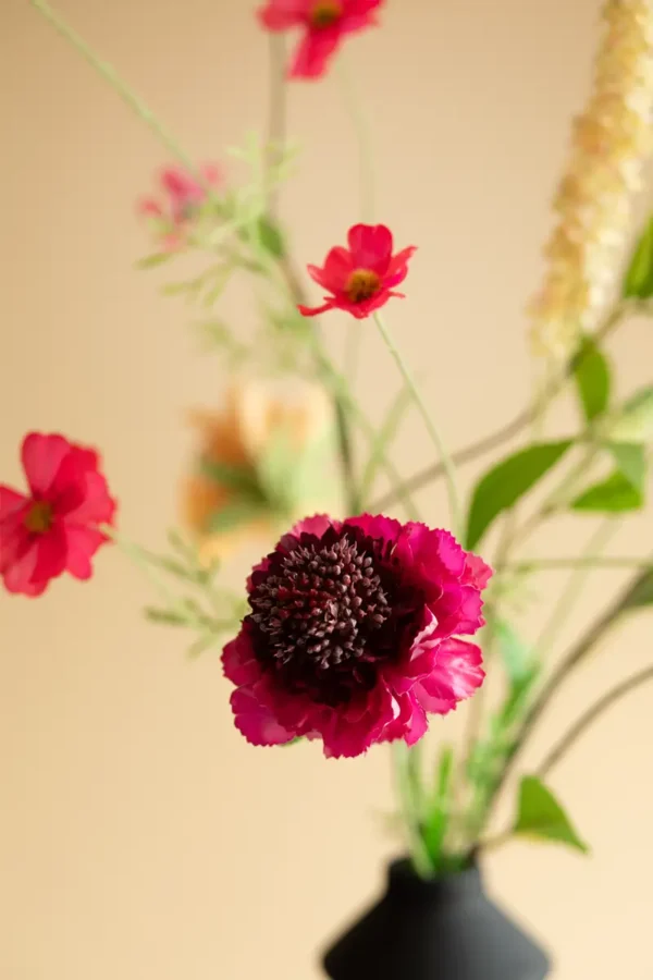 Close up of Jula Bloom’s Coco silk flower bouquet with orange, yellow and pink blooms