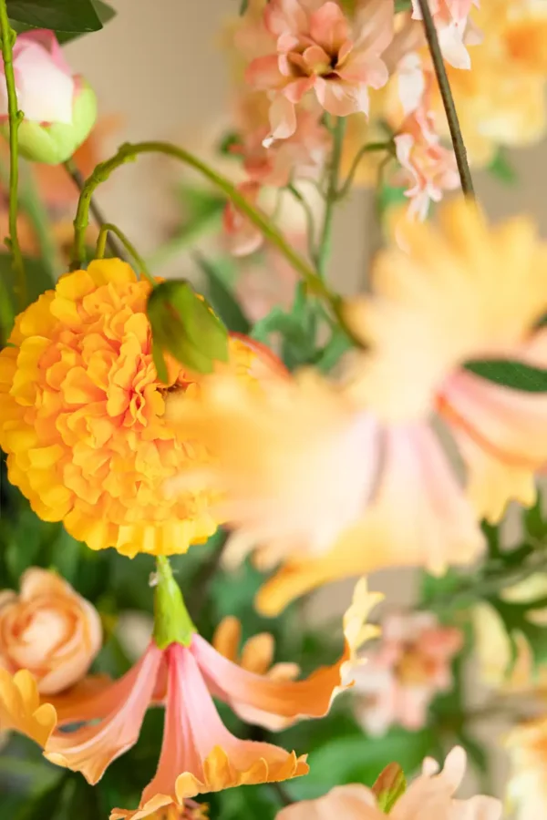 Close up of Jula Bloom’s Curie silk flower bouquet with peach and orange blooms