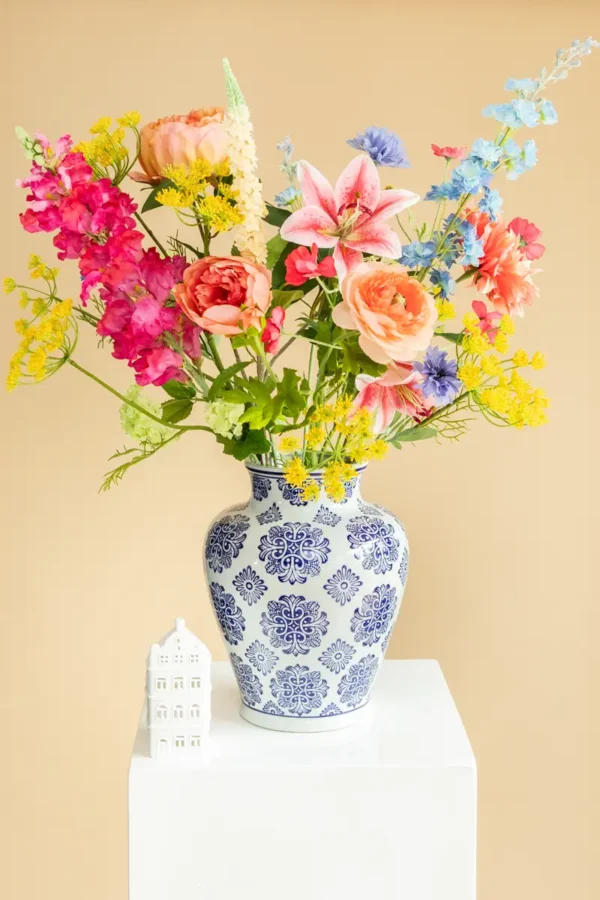 Jula Bloom’s Lovelace silk flower bouquet with multi-colored blooms, in a traditional white and blue painted vase