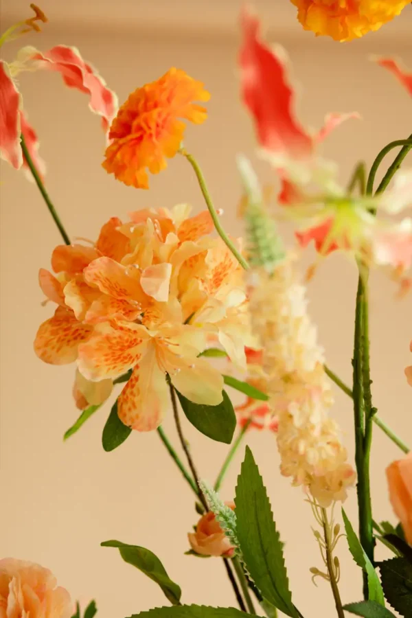 Close up of Jula Bloom’s Arc silk flower bouquet with orange and peach blooms