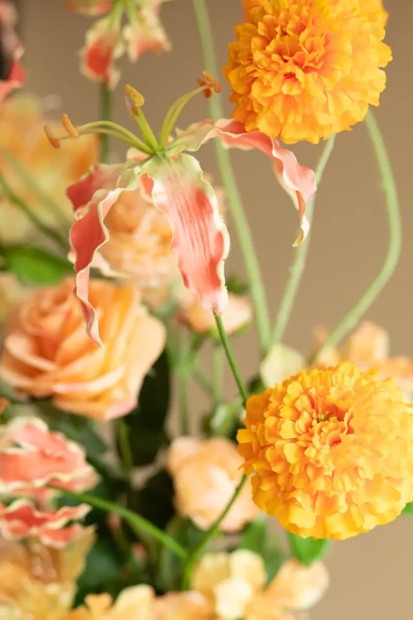 Close up of Jula Bloom’s Arc silk flower bouquet with orange and peach blooms