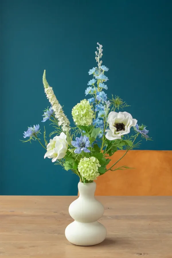 Jula Bloom’s Greta silk flower bouquet with white and blue blooms, in a white ceramic vase