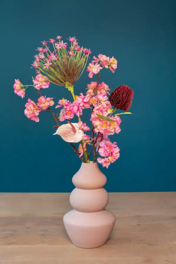 Jula Bloom’s Jacobs silk flower bouquet with pink and red blooms, in a pink vase