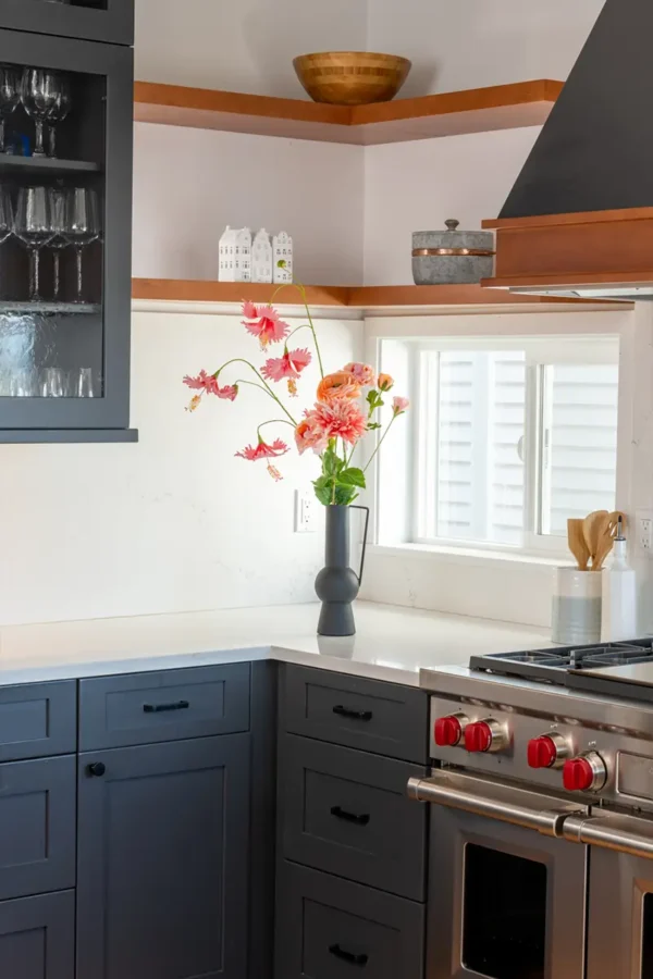 Jula Bloom’s Ginsbury silk flower bouquet with pink and orange blooms in a grey vase, situated on a kitchen counter