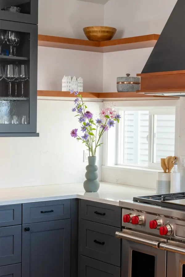 Jula Bloom’s Roosevelt silk flower bouquet with purple and pink blooms, in a grey vase on a kitchen counter top