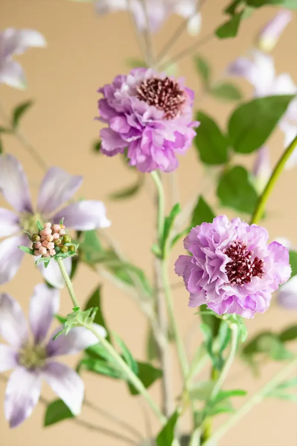 Close up of Jula Bloom’s Roosevelt silk flower bouquet with purple and pink blooms