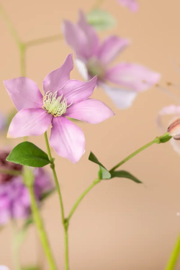 Close up of Jula Bloom’s Roosevelt silk flower bouquet with purple and pink blooms