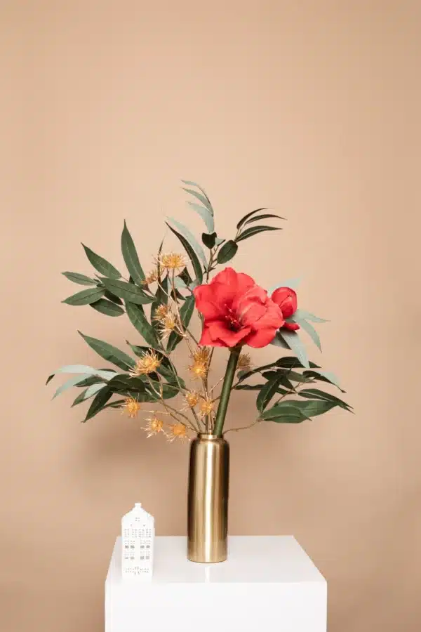 Jula Bloom’s Amelia silk flower bouquet with red blooms, gold thistles and green leaf, in a opaque studded brown vase, on a white pillar