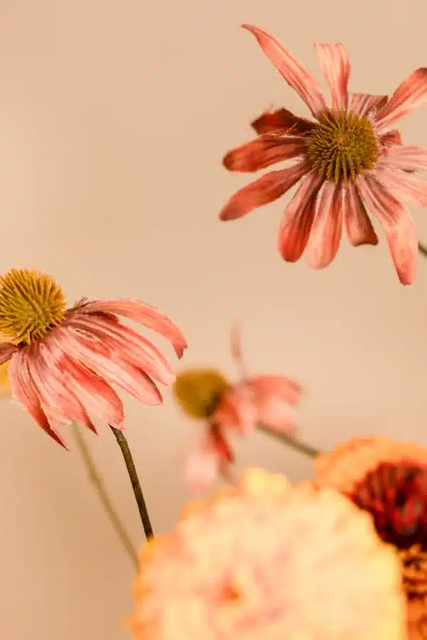 Jula Bloom’s Goodall silk flower bouquet with burnt orange and red blooms and gold leaf