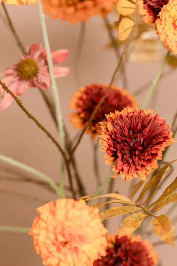 Jula Bloom’s Goodall silk flower bouquet with burnt orange and red blooms and gold leaf