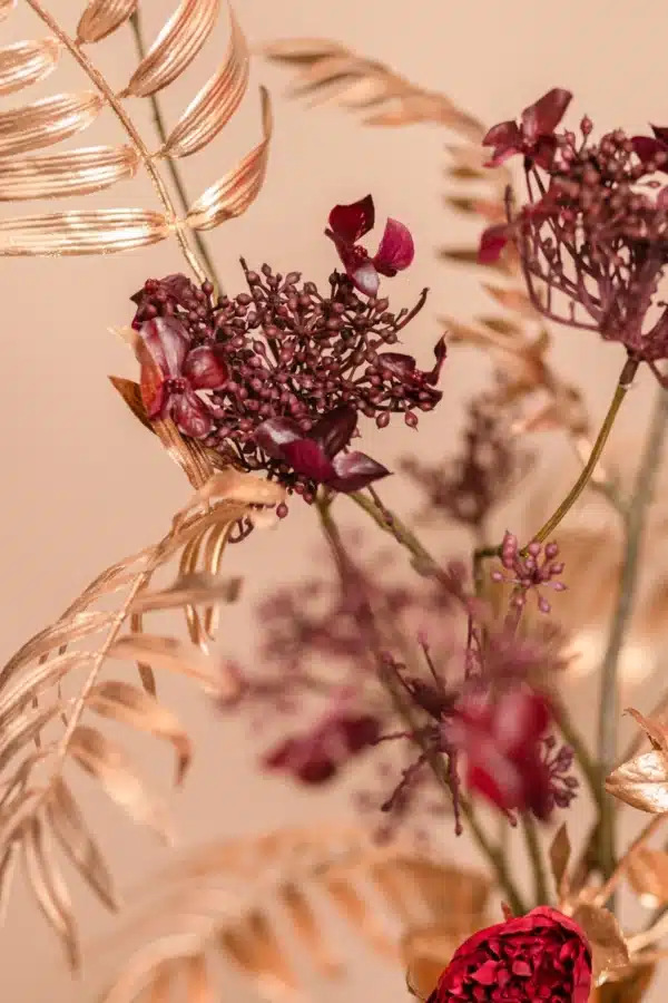 Jula Bloom’s Angelou silk flower bouquet with deep red blooms and gold leaf