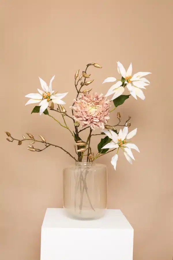 Jula Bloom’s Barrymore silk flower bouquet with white blooms and gold leaf, in a clear glass vase on a white pillar